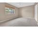 Cozy bedroom with neutral carpet, natural light from the window and neutral paint throughout at 302 E Orange Dr, Phoenix, AZ 85012