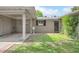 Home's front entrance features a covered entry, mature landscaping and convenient carport access at 302 E Orange Dr, Phoenix, AZ 85012