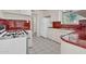 View of the kitchen showcasing the cabinetry, countertops, tile flooring, and retro appliances at 302 E Orange Dr, Phoenix, AZ 85012