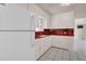 Bright kitchen featuring tile counters, white appliances, ample cabinets, and easy access to dining space at 302 E Orange Dr, Phoenix, AZ 85012