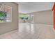 Bright living room featuring tile floors, large windows offering outdoor views, and neutral wall color at 302 E Orange Dr, Phoenix, AZ 85012