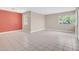 Spacious living room with neutral tile flooring, light walls, and bright natural light at 302 E Orange Dr, Phoenix, AZ 85012