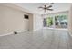 Open living space with tile flooring, ceiling fan, sliding glass doors to backyard, and neutral paint at 302 E Orange Dr, Phoenix, AZ 85012