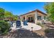 Expansive backyard with a covered patio, outdoor kitchen, fire pit, pool, spa, and lush landscaping, perfect for relaxation at 30406 N 54Th St, Cave Creek, AZ 85331
