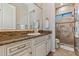Stylish bathroom featuring granite countertop, vanity, mirror, and glass-enclosed shower with tiled surround at 30406 N 54Th St, Cave Creek, AZ 85331