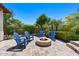Cozy backyard fire pit with Adirondack chairs, creating an inviting space for outdoor gatherings at 30406 N 54Th St, Cave Creek, AZ 85331