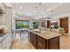 Open-concept kitchen with island seating, stainless steel appliances, and an adjacent dining area at 30406 N 54Th St, Cave Creek, AZ 85331