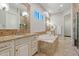 Luxurious main bathroom featuring a soaking tub, separate shower, double sinks, and tiled accents at 30406 N 54Th St, Cave Creek, AZ 85331