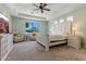 Inviting main bedroom with a large bed, ceiling fan, sitting area, and a view of the landscaped yard at 30406 N 54Th St, Cave Creek, AZ 85331