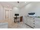 Bright home office with desk, chair, printer, and dresser with white drawers and decorative hardware at 30406 N 54Th St, Cave Creek, AZ 85331