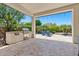 Inviting covered patio with outdoor kitchen including stainless steel grill and relaxing blue Adirondack chairs surrounding a fire pit at 30406 N 54Th St, Cave Creek, AZ 85331