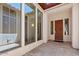 Bright patio with tiled flooring, many windows, and a stained wood front door at 30406 N 54Th St, Cave Creek, AZ 85331