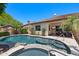 Stunning backyard featuring a pool with a waterfall feature leading to a hot tub and outdoor living spaces at 30406 N 54Th St, Cave Creek, AZ 85331