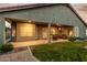 Inviting covered back patio with seating area, lush green lawn, and views of the landscaped yard at 321 W Brooks St, Gilbert, AZ 85233