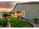 Lush green backyard with a covered patio, decorative landscaping, and manicured lawn, ideal for outdoor enjoyment at 321 W Brooks St, Gilbert, AZ 85233