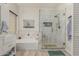 Spa-like bathroom with a soaking tub, glass-enclosed shower, and elegant fixtures at 321 W Brooks St, Gilbert, AZ 85233