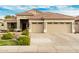 Attractive single-story house with desert landscaping, a tiled roof, and a spacious three-car garage at 321 W Brooks St, Gilbert, AZ 85233