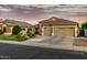 Charming single-story home with a three-car garage, manicured landscaping, and a tiled roof at 321 W Brooks St, Gilbert, AZ 85233