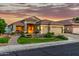 Desirable single-level home featuring a three-car garage, desert landscaping, and a charming tiled roof at 321 W Brooks St, Gilbert, AZ 85233