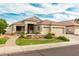 Beautiful single-Gathering home featuring desert landscaping, a tiled roof, and a three-car garage at 321 W Brooks St, Gilbert, AZ 85233
