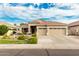 Charming single-story home with a three-car garage, desert landscaping, and a red tile roof at 321 W Brooks St, Gilbert, AZ 85233