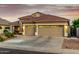 Inviting home featuring a three-car garage, desert landscaping, and a beautifully tiled roof at 321 W Brooks St, Gilbert, AZ 85233