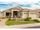 Beautiful home with desert landscaping, a decorative pond, and a spacious three-car garage at 321 W Brooks St, Gilbert, AZ 85233