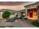 Charming home entrance with a flowing water feature, desert landscaping, and a covered porch at 321 W Brooks St, Gilbert, AZ 85233