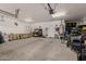 Spacious garage featuring a workbench, ample storage, and room for multiple vehicles at 321 W Brooks St, Gilbert, AZ 85233