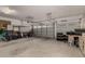 Clean and organized garage with roll-up door, storage solutions, and space for vehicles at 321 W Brooks St, Gilbert, AZ 85233