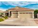 Charming single-story home with a three-car garage and desert landscaping under beautiful blue sky at 321 W Brooks St, Gilbert, AZ 85233