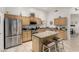 Well-lit kitchen with stainless steel appliances and a convenient island with barstool seating at 321 W Brooks St, Gilbert, AZ 85233