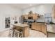 Bright kitchen featuring wooden cabinets, an island with seating, and modern appliances at 321 W Brooks St, Gilbert, AZ 85233