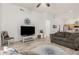 Cozy living room with tile flooring, large TV, and comfortable seating, perfect for relaxing and entertaining at 321 W Brooks St, Gilbert, AZ 85233