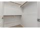 Walk-in closet with wooden hanging bars and carpet flooring at 321 W Brooks St, Gilbert, AZ 85233