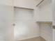 Empty walk-in closet, featuring wooden hanging bars and ample space at 321 W Brooks St, Gilbert, AZ 85233