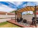 Backyard featuring a covered patio area with outdoor seating and a built-in grill at 3514 E Desert Willow Rd, Phoenix, AZ 85044