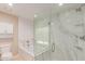 Bathroom with a glass-enclosed shower, tub, and marble tile at 3514 E Desert Willow Rd, Phoenix, AZ 85044