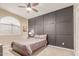 Cozy bedroom with a gray accent wall, wood blinds, and neutral carpet at 3514 E Desert Willow Rd, Phoenix, AZ 85044