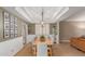 Dining room with modern lighting, neutral colors, and a view to the adjacent living areas at 3514 E Desert Willow Rd, Phoenix, AZ 85044