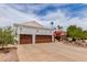 A beautiful three-car garage with a wide driveway and well maintained landscape at 3514 E Desert Willow Rd, Phoenix, AZ 85044
