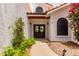 Elegant front entrance featuring double doors, desert landscaping, and exterior lighting at 3514 E Desert Willow Rd, Phoenix, AZ 85044