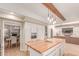 Open concept kitchen featuring white cabinets, a butcher block island, and stainless appliances at 3514 E Desert Willow Rd, Phoenix, AZ 85044