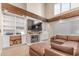 Cozy living room featuring a brick fireplace, built-in shelving, and comfortable seating at 3514 E Desert Willow Rd, Phoenix, AZ 85044