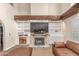 Bright living room with custom built-ins, a brick fireplace, and a wooden beam mantel at 3514 E Desert Willow Rd, Phoenix, AZ 85044