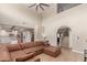 Spacious living room with high ceilings, wood floors, and an open layout to the kitchen at 3514 E Desert Willow Rd, Phoenix, AZ 85044