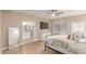 Serene main bedroom features wood floors, a ceiling fan, and a bathroom entrance at 3514 E Desert Willow Rd, Phoenix, AZ 85044