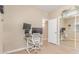 A bright office with light tan walls, a neutral-toned chair, and mirrored closet doors at 3514 E Desert Willow Rd, Phoenix, AZ 85044