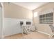 A bright office with light tan walls, a neutral-toned chair, and a large window with blinds at 3514 E Desert Willow Rd, Phoenix, AZ 85044
