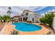 Backyard oasis featuring a blue swimming pool, well-manicured landscaping, and desert foliage at 3514 E Desert Willow Rd, Phoenix, AZ 85044